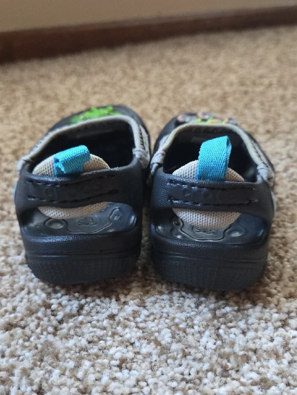 CROCS Kids Black and Beige Clog with Bright Blue Pull Tabs and Charms
